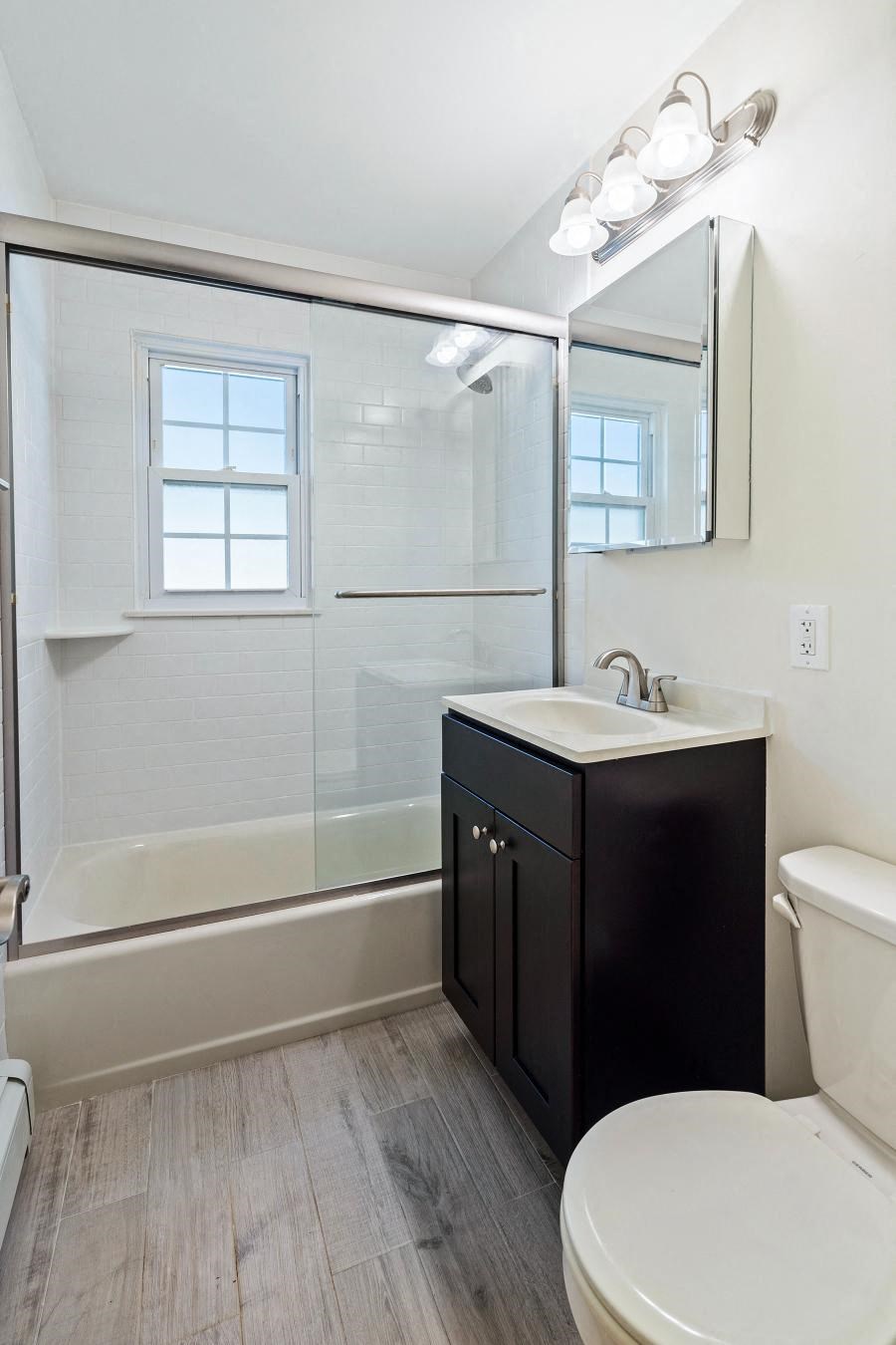 a bathroom with a sink toilet and shower