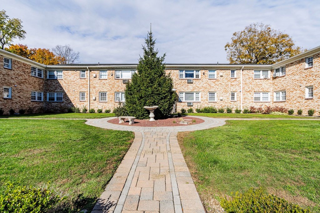 a brick building with a courtyard with a fountain