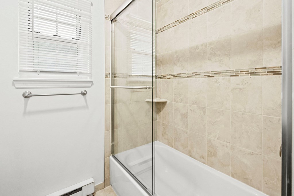 a bathroom with a shower and a bath tub