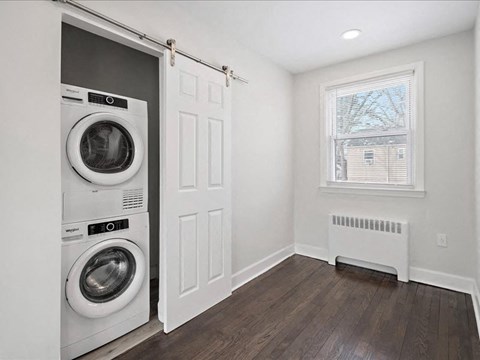A laundry room with a washer and dryer built into the wall.