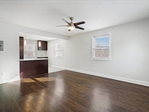 A room with a ceiling fan and a window.