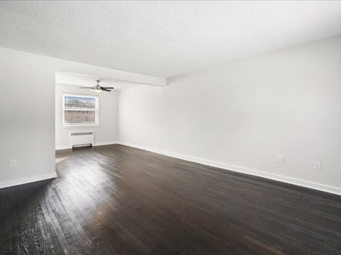 A room with wooden floors and white walls.