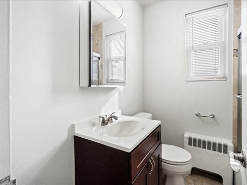 A bathroom with a white toilet and a white sink.