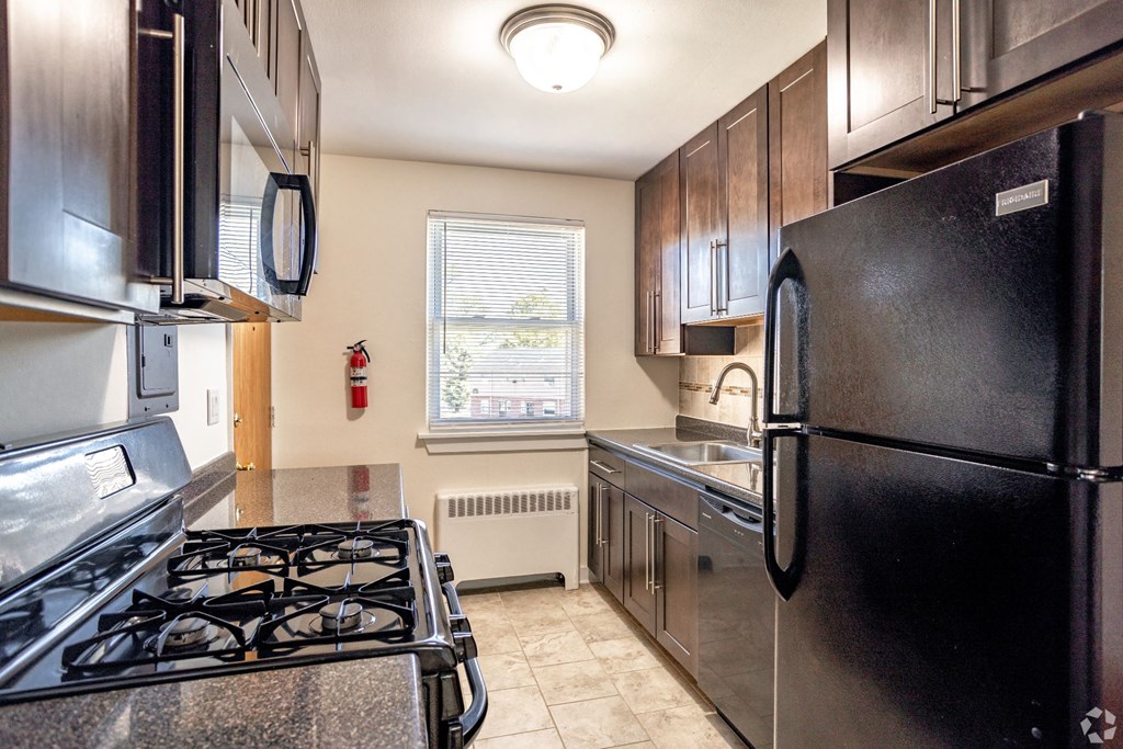 a kitchen with stainless steel appliances and black appliances