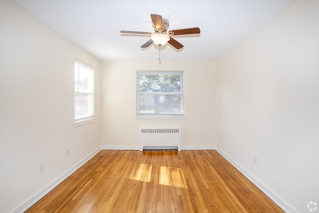a living room with hardwood floors and a ceiling fan