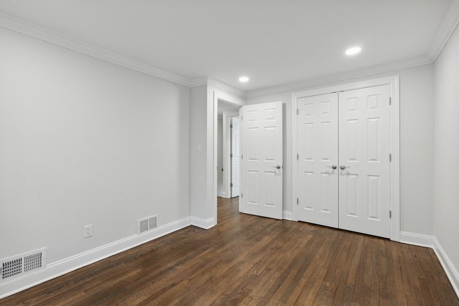 a bedroom with two closets and a door to a hallway