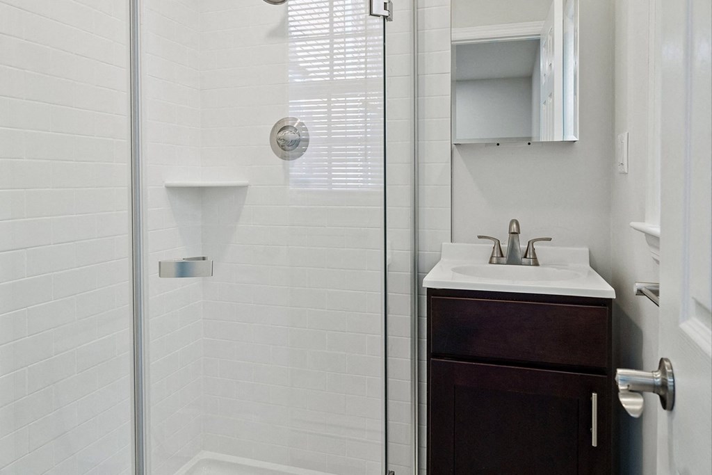 a small bathroom with a shower and a sink