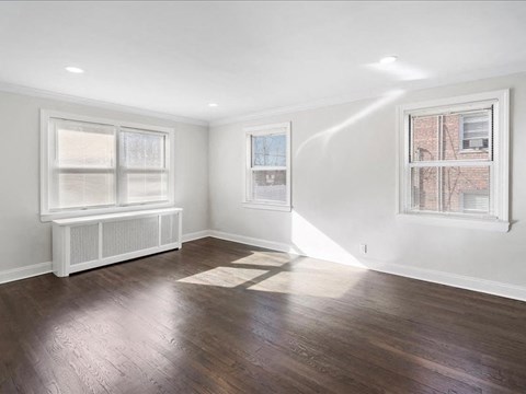 A room with a window and a radiator on the wall.