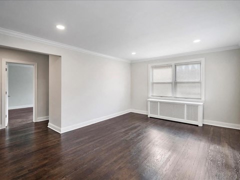 A room with a window and a radiator on the wall.