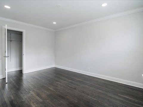 A room with a wooden floor and a white door.