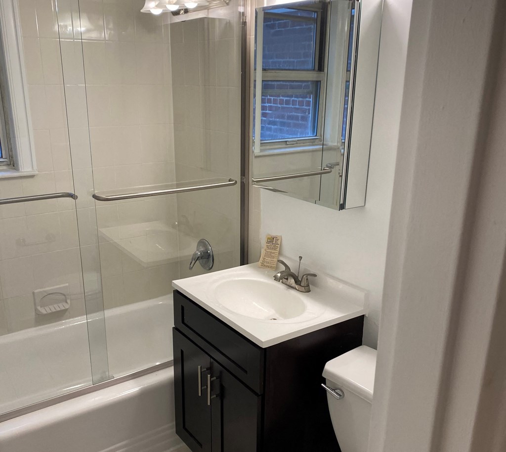 a small bathroom with a sink and a shower