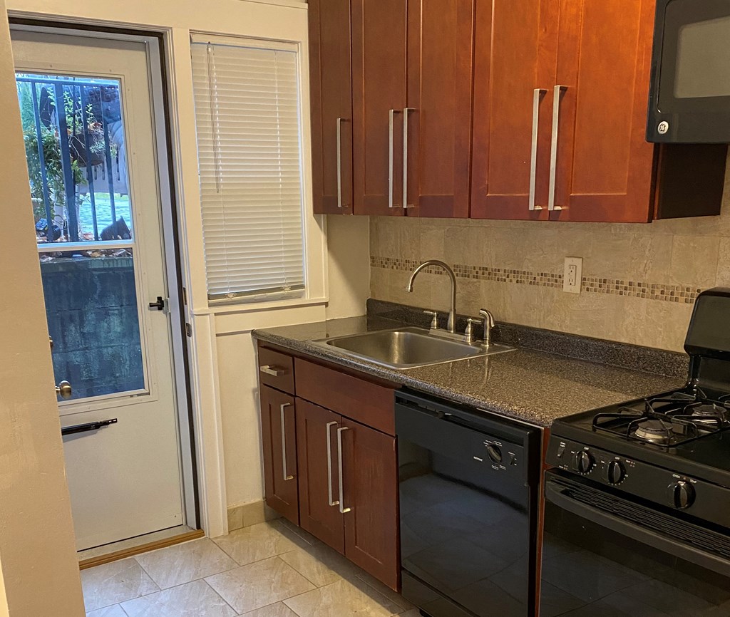 a kitchen with a sink and a door to a patio