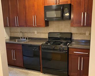 a kitchen with a stove microwave and sink
