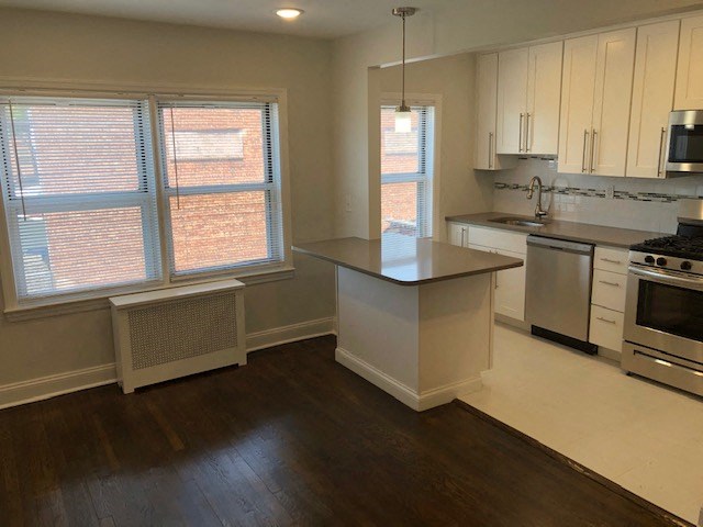 an empty kitchen with an island in the middle