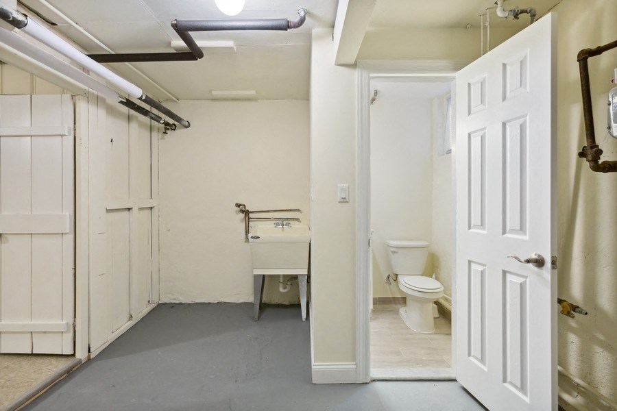 a bathroom with a sink and a toilet and a door