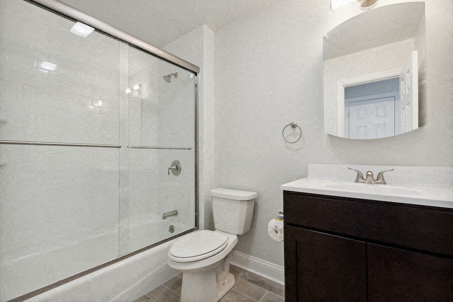 a bathroom with a shower toilet and sink