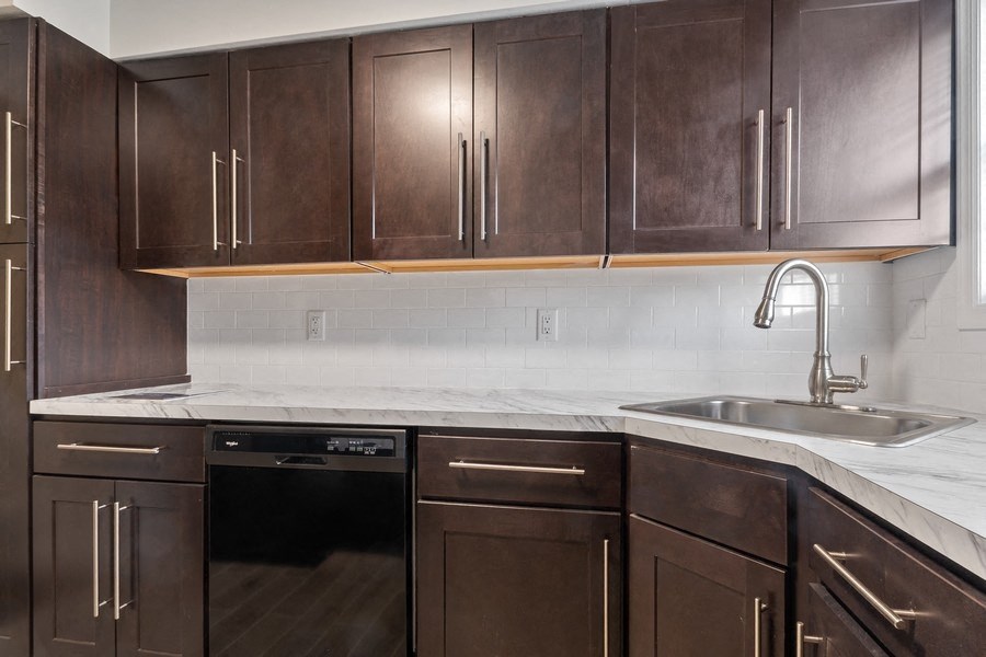 a kitchen with wooden cabinets and a sink