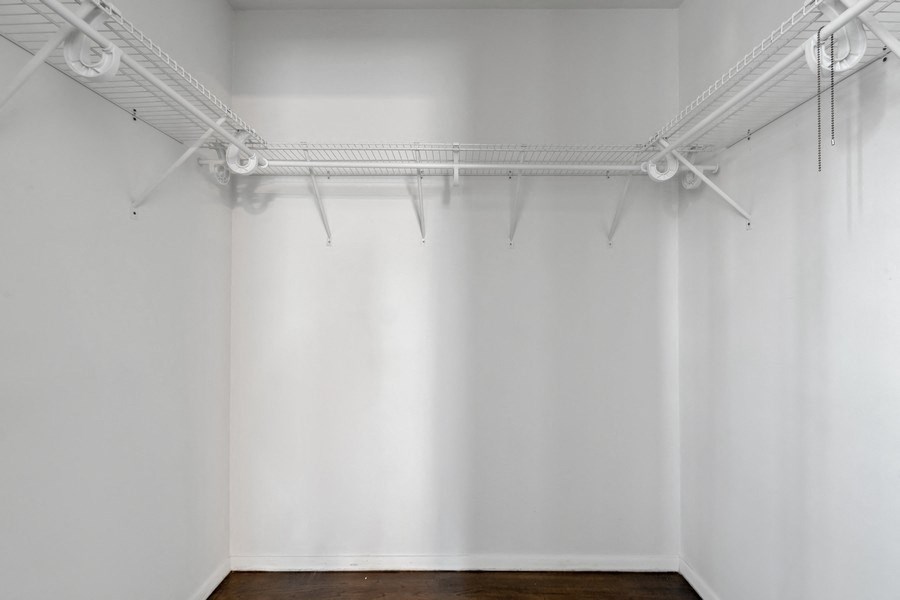 an empty room with white walls and a wood floor