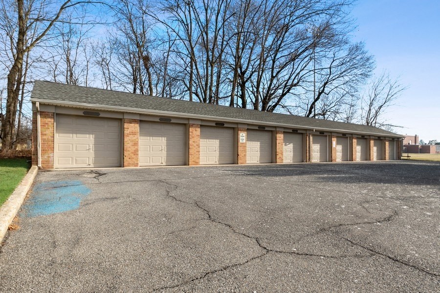a row of garages in front of a parking lot