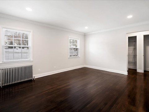 A room with wooden floors and white walls.