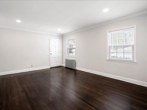 A room with a wooden floor and a window.