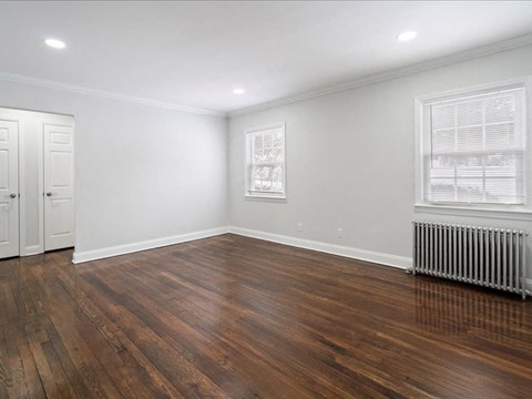 A room with wooden floors and white walls.