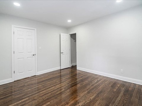A room with wooden floors and white walls.