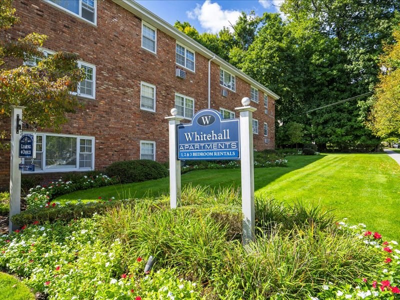 a sign in front of a brick building