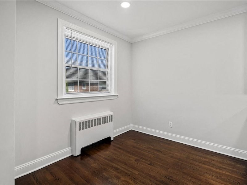 a living room with a radiator and a window