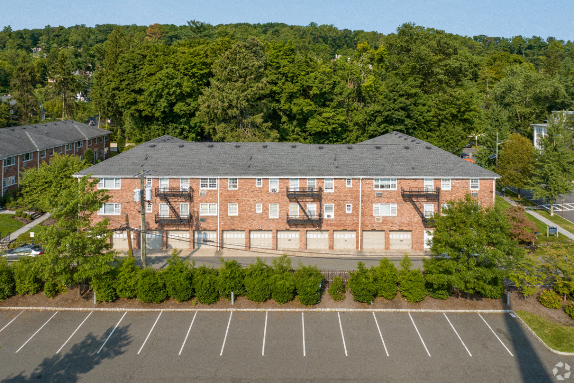 an aerial view of a brick building in a parking lot