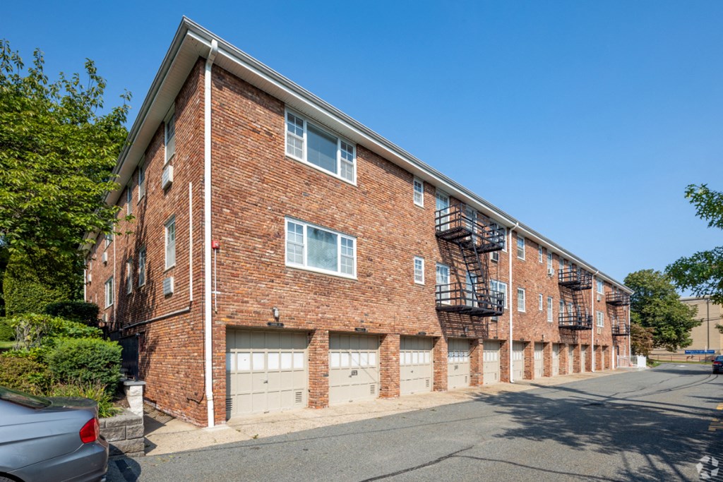 an old brick building with garage doors and a fire escape