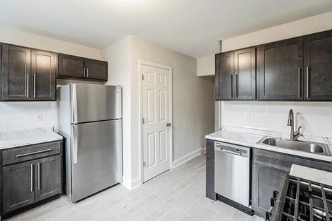 a kitchen with stainless steel appliances and black cabinets