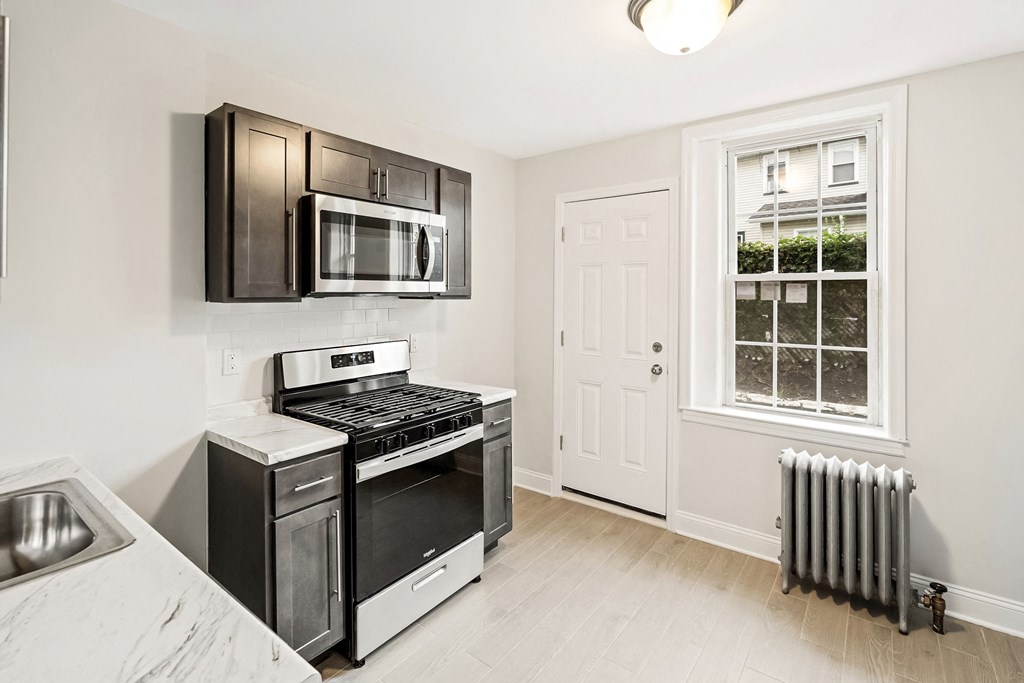 a kitchen with stainless steel appliances and a window