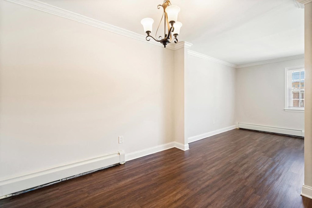 A room with a wooden floor and a chandelier.