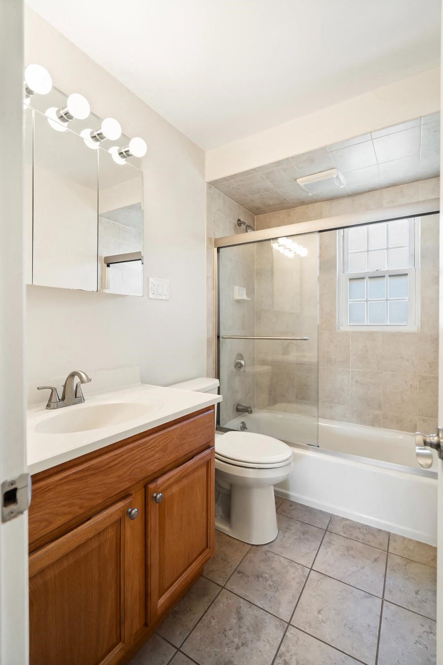 A bathroom with a toilet, sink, and a shower.