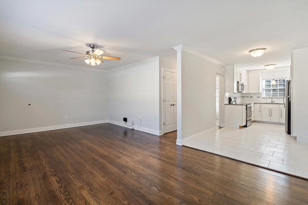 A room with wooden floors and a ceiling fan.