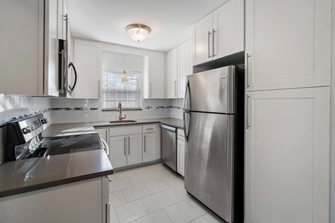 A modern kitchen with a stainless steel refrigerator and other appliances.