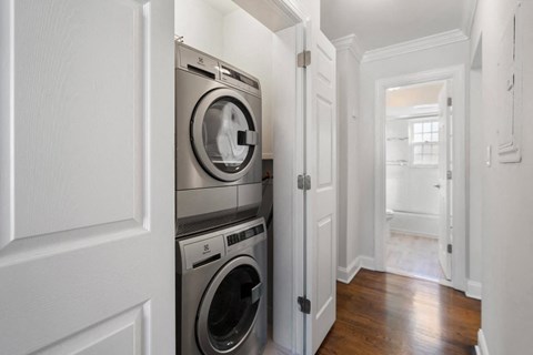 A washer and dryer are built into a wall in a laundry room.