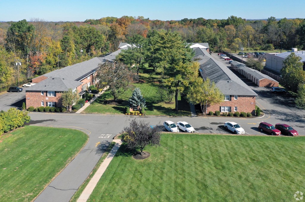 an aerial view of a building with cars parked in front of it