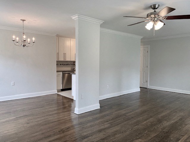 an empty living room with a ceiling fan