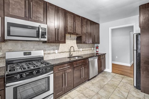 a kitchen with stainless steel appliances and wooden cabinets