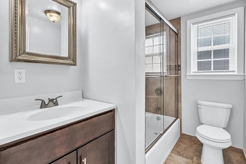 a bathroom with a sink toilet and a shower