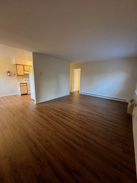 an empty living room with a wood floor