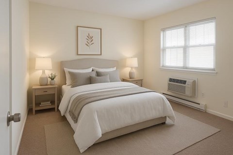 A bedroom with a large bed and two lamps.