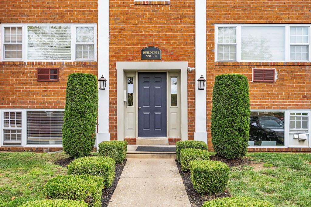 the front of a brick building with a blue door