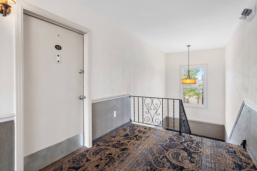 the entryway of a home with a door to a balcony and a window