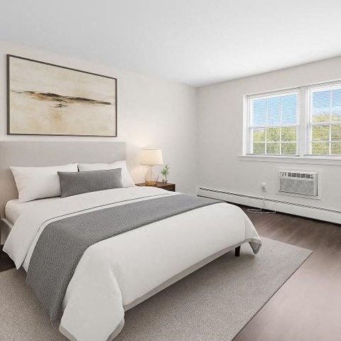 A bedroom with a large bed and a painting on the wall.
