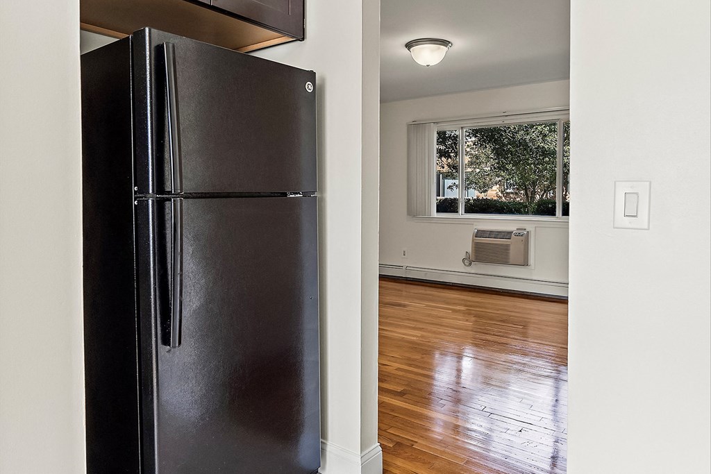 a renovated kitchen with a refrigerator and a window