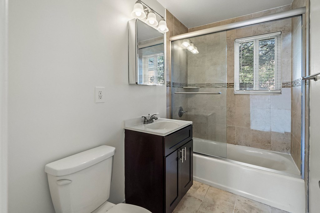 an empty bathroom with a toilet sink and shower
