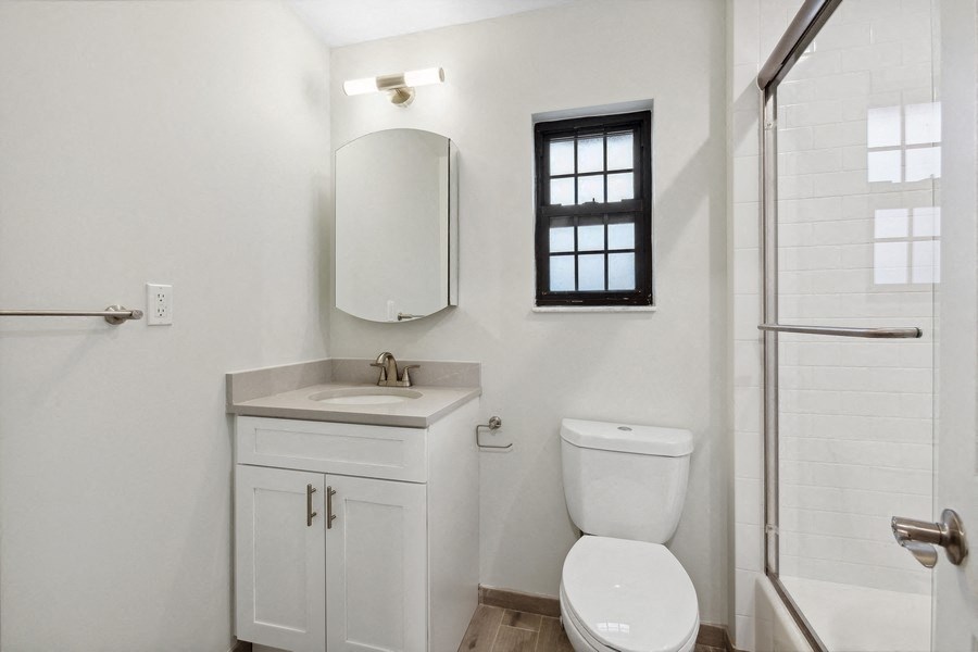 a bathroom with a toilet and a sink and a shower